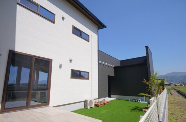 アメリカンガレージと大人モダンな室内が鮮やかな対比を描く段差リビングのある家 - 外観背面