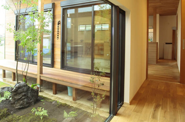 大開口の窓から庭を望むピクチャーウィンドウと木の温もりに満ちた平屋 - リブワーク - 外構・室内